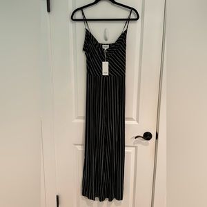 Fun black and white jumpsuit.  Drape neck and flattering stripes.